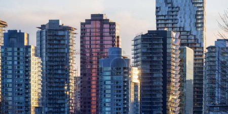 Photo for Highrise Residential and Commercial Buildings in Modern Downtown City. Vancouver, British Columbia, Canada. Winter Sunset. - Royalty Free Image