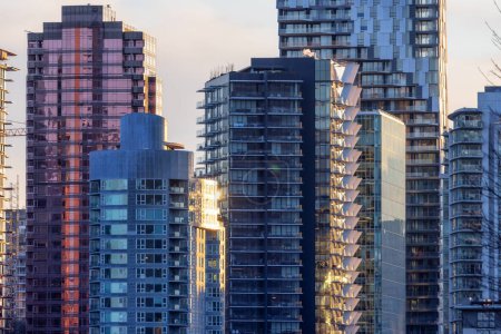 Foto de Highrise Residential and Commercial Buildings in Modern Downtown City. Vancouver, British Columbia, Canada. Winter Sunset. - Imagen libre de derechos