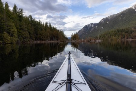 Photo for Kayaking in calm water with Canadian Mountain Landscape Background. Buntzen Lake in Vancouver, British Columbia, Canada. - Royalty Free Image