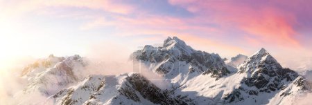 Téléchargez les photos : Aerial View from Airplane of Snow Covered Canadian Mountain Landscape in Winter. Colorful Pink Sky Art Render. Near Squamish, North of Vancouver, British Columbia, Canada. - en image libre de droit