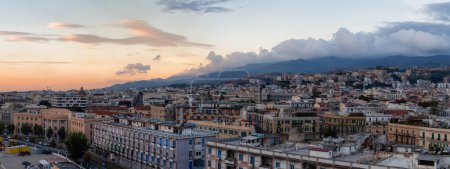 Photo for Homes and Apartment Buildings in a touristic city Messina, Sicilia, Italy. Cloudy Sunrise Sky. Aerial - Royalty Free Image