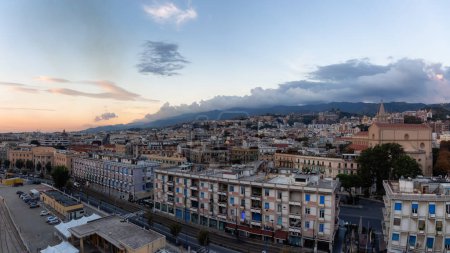 Photo for Homes and Apartment Buildings in a touristic city Messina, Sicilia, Italy. Cloudy Sunrise Sky. Aerial - Royalty Free Image