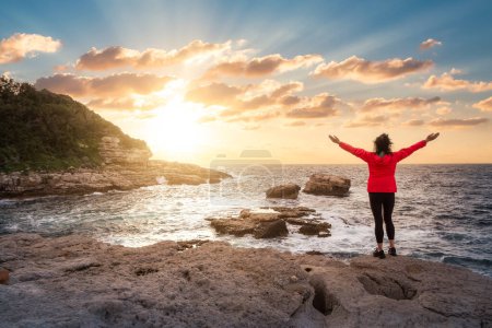 Téléchargez les photos : Femme sur la côte rocheuse dans un parc à Touristic Town, Sorrente, Italie. Côte amalfitaine. Voyage d'aventure. Sunset Sky Art Render - en image libre de droit