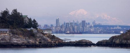 Photo for Cabins on Passage Island with Downtown City Buildings and Mnt Baker in Background. Vancouver, British Columbia, Canada. - Royalty Free Image