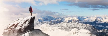 Photo for Adventurous Man Standing on top of Mountain Cliff. Exteme Adventure Composite. 3d Rendering Peak. Background Aerial Image from British Columbia, Canada. - Royalty Free Image