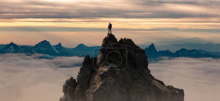 Photo for Epic Adventure Composite of Man Hiker on top of a rocky mountain. Dramatic Sunset Sky. 3d Rendering peak. Background landscape from North America. Freedom Concept. - Royalty Free Image