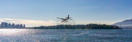 Photo for Downtown Vancouver, BC, Canada - July 18, 2017: Seaplane landing in Vancouver Harbour during sunny summer day. - Royalty Free Image