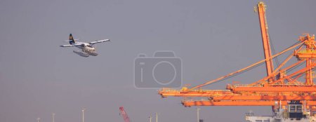 Photo for Downtown Vancouver, BC, Canada - September 20, 2023: Seaplane landing in Coal Harbour. - Royalty Free Image