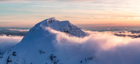 Photo for Snow covered Mountain Peak. Canadian Nature Aerial Background. British Columbia, Canada. Sunset Sky - Royalty Free Image