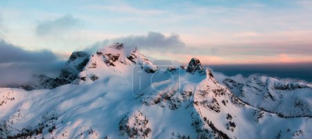 Photo for Mountain Peak Covered in Snow. Winter Season. Cloudy Sunset. Aerial View. Squamish, BC, Canada. - Royalty Free Image