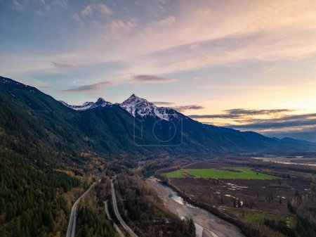 Photo for Scenic Road in Valley by the River, surrounded by Mountains. Sunset, Fall Season. Aerial Landscape. Fraser Valley, British Columbia Canada. - Royalty Free Image
