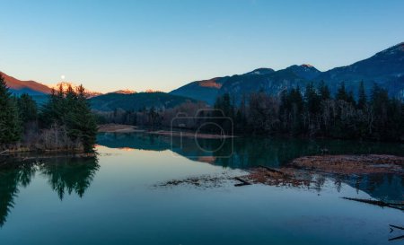 Photo for Canadian Mountain Landscape, peaceful river with green trees. Sunny Sunset. Squamish, British Columbia, Canada. - Royalty Free Image