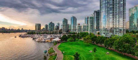 Photo for Buildings in False Creek, Downtown Vancouver, BC, Cannada. Dramatic Sunset. Cityscape Panorama - Royalty Free Image