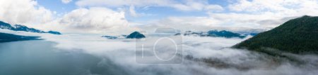 Photo for Howe Sound with Canadian Mountain Landscape Nature Aerial Background. Dramatic Cloudy Sky. BC, Canada. - Royalty Free Image