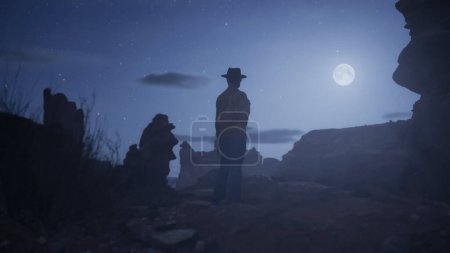 Cowgirl standing in Rocky Desert with Rock Formations. Sandstone. Night with stars and moonlight,
