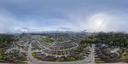 Aerial 360 Panorama View of Residential Homes in Chilliwack. Cloudy and Foggy Morning. Mountain Landscape Background. BC, Canada.
