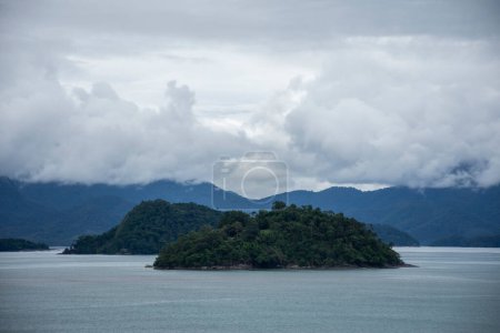 Photo for Beautiful view to foggy weather clouds over green rainforest mountains on ocean area, Paraty, Rio de Janeiro, Brazil - Royalty Free Image