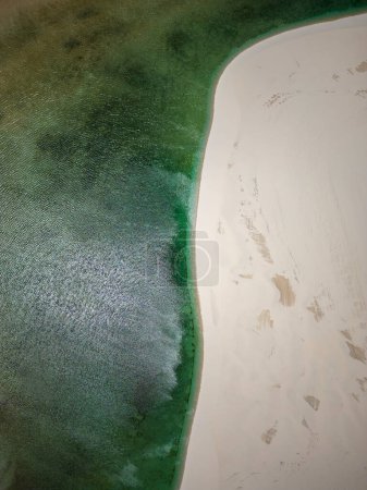 Foto de Beautiful aerial view to white sand dunes and green rainwater pools in Lenis Maranhenses, near Barreirinhas, Maranho, Brazil. - Imagen libre de derechos