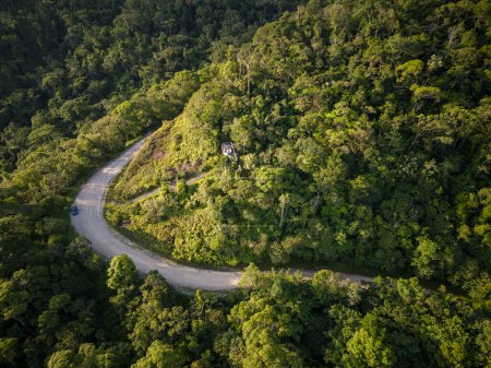 Photo for Beautiful aerial view to sharp turn on road in green rainforest mountains, Guaraqueaba area, Paran, Brazil. - Royalty Free Image