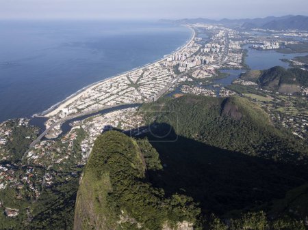 Beautiful aerial view to green rainforest mountains, city and ocean in Rio de Janeiro, Brazil