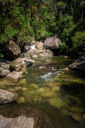 Beautiful waterfall with rocks and green rainforest, Serrinha do Alambari, Mantiqueira Mountains, Rio de Janeiro, Brazil
