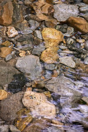 Rocks in crystal clear water river bottom in green rainforest area, Serrinha do Alambari, Mantiqueira Mountains, Rio de Janeiro, Brazil