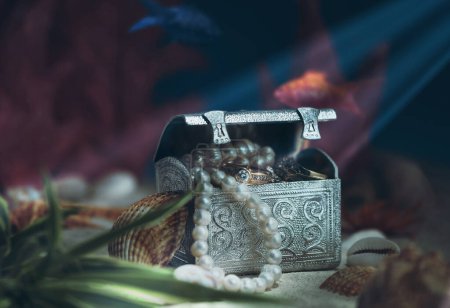 Photo for Fantasy on the theme of treasures lying on the bottom of the sea or ocean. Jewelry lying in a chest under water. - Royalty Free Image
