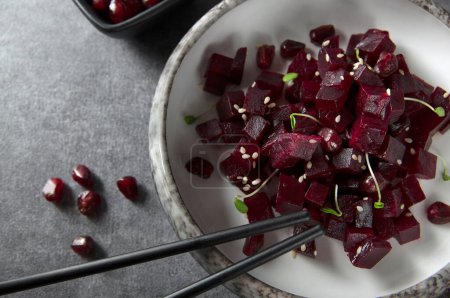 Photo for Fresh beetroot salad diced with pomegranate seeds, sesame seeds and herbs. - Royalty Free Image