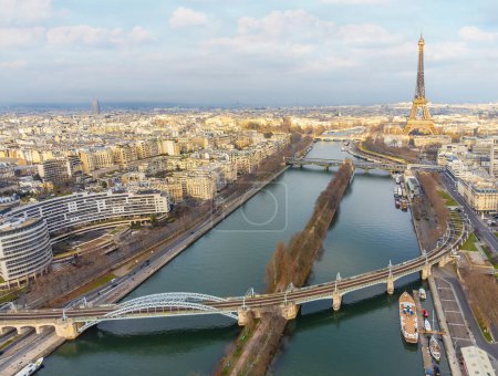 Aerial drone view of the Eiffel Tower. Wrought-iron lattice tower on the Champ de Mars and the Seine river in Paris, France.