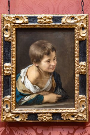 Foto de Londres, Reino Unido - 18 de mayo de 2023: Pintura Bartolomé Esteban Murillo titulada A Peasant Boy lean on a Sill. Representa a un niño campesino apoyado en un bloque de piedra astillada o alféizar y mira hacia algo o alguien que le hace sonreír - Imagen libre de derechos