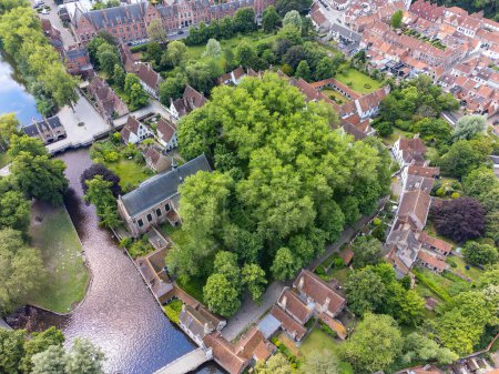 Photo for Aerial drone view of the Princely Beguinage Ten Wijngaerde, minnewater park and bridge. It is the only preserved beguinage in the Belgian city of Bruges. - Royalty Free Image