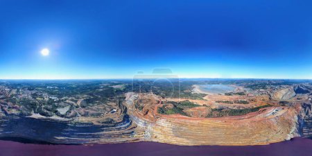 Photo for Aerial panoramic view of Corta Atalaya in 360 degrees, with mining levels at open mine pit. Drone view of deep excavation of pyrite and extraction of minerals of copper and gold in Minas de Riotinto - Royalty Free Image