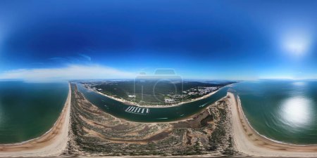 Aerial 360 degrees view of the Rompido Arrow (La Flecha del Rompido), a sand bank formed on the Rompido and Portil beaches that already reaches La Bota beach, in Punta Umbria, Huelva province