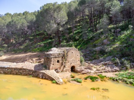 Aerial drone view of old watermill in the shore of Odiel river in the hiking route of the water mills along the Odiel river from Sotiel Coronada, in Huelva province, Andalusia, Spain