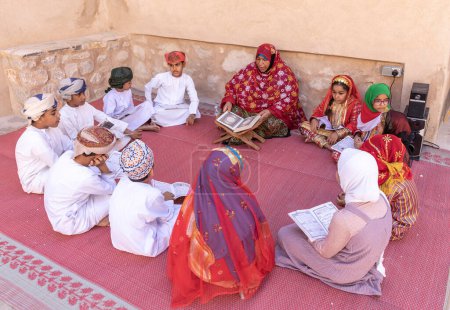 Photo for Nizwa, Oman, 2nd December 2022: omani kids reciting a Holy Book - Royalty Free Image