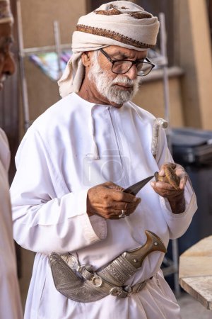 Photo for Nizwa, Oman, 2nd December 2022: omani man in traditional outfit at the weapon market - Royalty Free Image
