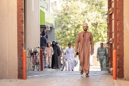 Foto de Nizwa, Oman 2nd December 2022: omani men walking on street - Imagen libre de derechos