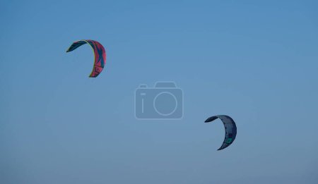 Photo for Kitesurf kites against clear sky. Kites flying in air scenic background. Imbros Island. Gokceada, Canakkale Turkey 08.20.2022 - Royalty Free Image