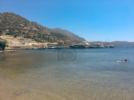 Photo for People enjoying the sea and the beach of the ancient city of Knidos on the Knidos Data Peninsula, Mula, TURKEY - Royalty Free Image