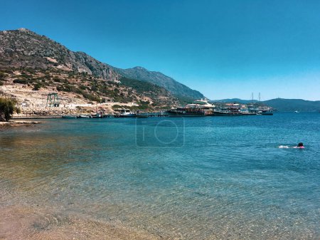 Photo for People enjoying the sea and the beach of the ancient city of Knidos on the Knidos Data Peninsula, Mula, TURKEY - Royalty Free Image
