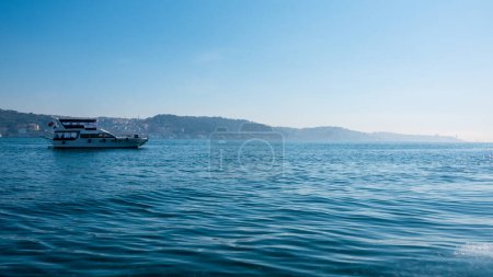 Photo for A tour boat sailing off the shores of Ortakoy in the Bosphorus, Istanbul. - Royalty Free Image