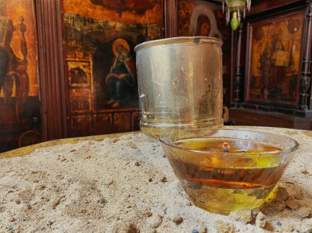 Photo for Wishing  candle in a glass on an iron table in church - Royalty Free Image