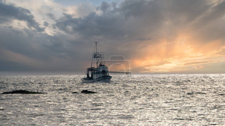 Photo for Fishing Trawler in Gokceada sea at sunset. Imbros island Canakkale, Turkey - Royalty Free Image