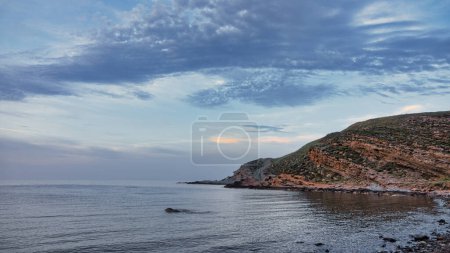 Photo for Yildizkoy beach view from the green hills of Gokceada at sunset,  Yildizkoy coast is the one of popular beach in Gokceada. Canakkale, Turkey - Royalty Free Image