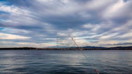 Téléchargez les photos : Canne à pêche dans la mer avec ciel nuageux en arrière-plan. Kilitbahir, canakkale, Turquie - en image libre de droit