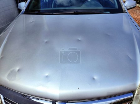 car hood dented by hail
