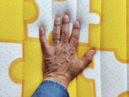 Photo for Male hand on memory foam mattress - Royalty Free Image