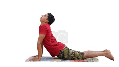 Photo for Sporty boy doing exercises for flexible spine on studio background, yoga asana from Surya Namaskar sequence, Sun Salutation complex, urdhva mukha shvanasana - Royalty Free Image