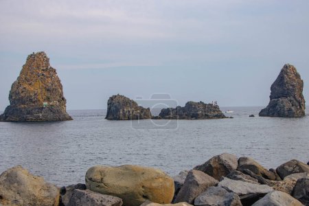 Photo for Lavic rock formation off the coast of Aci Trezza in the so called cyclops riviera - Royalty Free Image