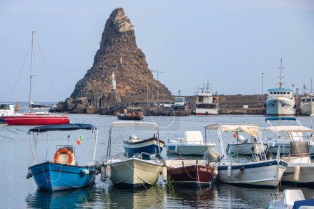 Photo for At Aci TRezza, Italy, On 08-08-22, The little harbor and distinctive lavic rock formation called islands of cyclops - Royalty Free Image